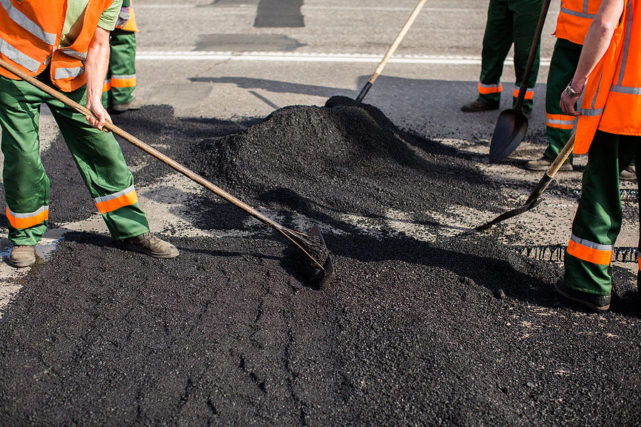 repairing the road with asphalt