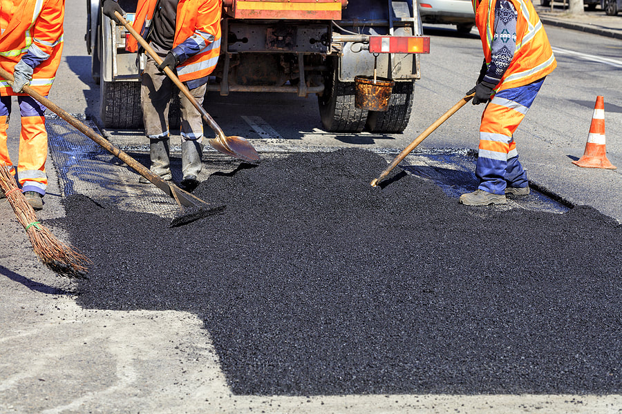 repairing road with asphalt